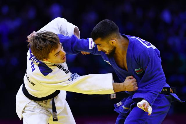 Finland's Luukas Saha (white competes against Azerbaijan's Turan Bayramov in the men's under 66 kg round of 64 at the World Judo Championships in Baku on October 5, 2026. (Photo by Anne-Christine POUJOULAT / AFP)