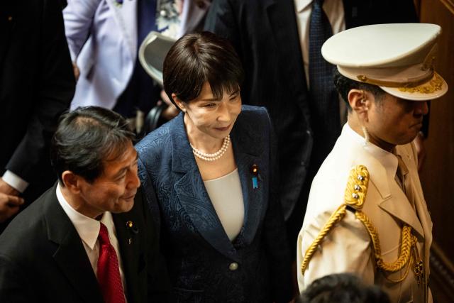 Japan's Prime Minister Sanae Takaichi (C) leaves after the opening ceremony of an extraordinary Diet session at the House of Councillors at the National Diet in Tokyo on October 5, 2026. (Photo by Yuichi YAMAZAKI / AFP)