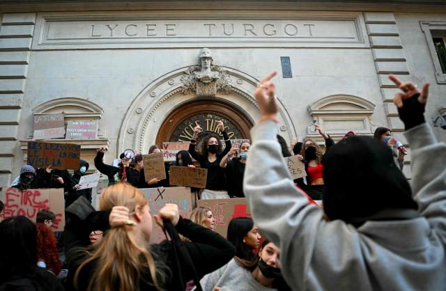 Protesting students gather and hold placards as they carry out a blockading action at the Turgot secondary school, in Paris, on October 5, 2026. The start of a "black week"? Hundreds of high schools are going to close again, at least partially, on October 5, 2026, on the eve of a new day of mobilisation, which unions are calling on people to join, and as calls for a hard blockade are flourishing on social media as students demand more resources for their schools and denouncce the unsanitary state of buildings, overcrowded classes, or unreplaced absences, particularly in working-class neighbourhoods, or even the inequalities created by Parcoursup. (Photo by LOU BENOIST / AFP)