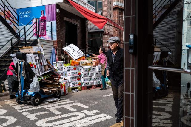 Shop staff manage goods near Mangwon Market in Seoul on October 5, 2026. (Photo by Philip FONG / AFP)