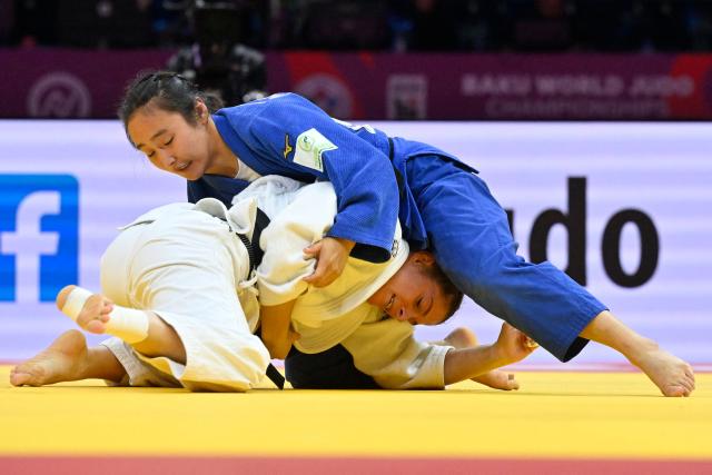 Germany's Mascha Ballhaus (white) competes against Mongolia's Nandin-Erdene Myagmarsuren in the women's under 52 kg round of 16 at the World Judo Championships in Baku on October 5, 2026. (Photo by Alexander NEMENOV / AFP)