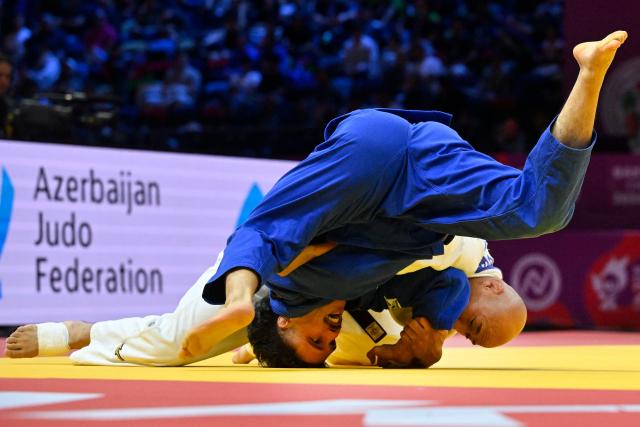 Mongolia's Baskhuu Yondonperenlei (white) competes against Spain's David Garcia Torne in the men's under 66 kg quarter-final at the World Judo Championships in Baku on October 5, 2026. (Photo by Alexander NEMENOV / AFP)