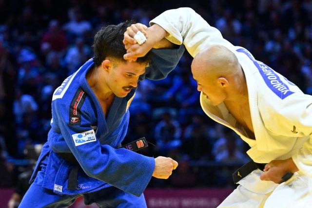 Mongolia's Baskhuu Yondonperenlei (white) competes against Spain's David Garcia Torne in the men's under 66 kg quarter-final at the World Judo Championships in Baku on October 5, 2026. (Photo by Alexander NEMENOV / AFP)