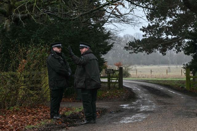 (FILES) Policemen stand at an entrance to Wood Farm on the royal family's Sandringham Estate in Norfolk, eastern England on February 19, 2026, where former prince Andrew was arrested earlier in the day. Disgraced ex-prince Andrew Mountbatten-Windsor has launched a legal challenge over search warrants for his royal estate homes issued before his February arrest, Britain's judiciary confirmed Monday, October 5, in an unprecedented royal move in modern times. (Photo by JUSTIN TALLIS / AFP)