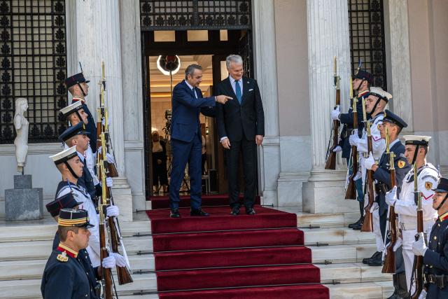 Greek Prime Minister Kyriakos Mitsotakis (L) and Lithuanian President Gitanas Nauseda react before their meeting at the Maximos Mansion, in Athens, on October 5, 2026. (Photo by Angelos TZORTZINIS / AFP)