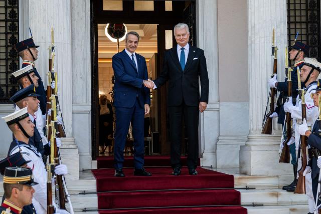 Greek Prime Minister Kyriakos Mitsotakis (L) shakes hands with Lithuanian President Gitanas Nauseda, before their meeting at the Maximos Mansion, in Athens, on October 5, 2026. (Photo by Angelos TZORTZINIS / AFP)