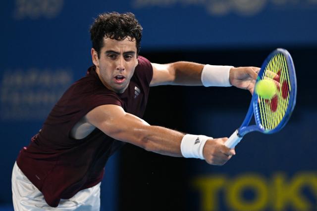 Spain's Jaume Munar hits a return against compatriot Carlos Alcaraz during their men's singles semi-final tennis match at the ATP Tour Japan Open Tennis Championships at the Ariake Tennis Forest Park in Tokyo on October 5, 2026. (Photo by Rie KIKUCHI / AFP)