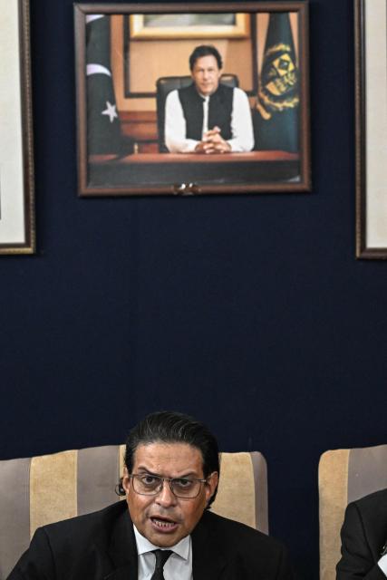 Salman Akram Raja, secretary general of the Pakistan Tehreek-e-Insaf (PTI) party, addresses a press conference with a portrait of jailed former prime minister Imran Khan in the background at Khyber Pakhtunkhwa House in Islamabad on October 5, 2026. A march protesting the imprisonment of former Pakistani prime minister Imran Khan kicked off on October 4 in the country's northwest after talks to avoid the demonstration stalled. (Photo by Aamir QURESHI / AFP)