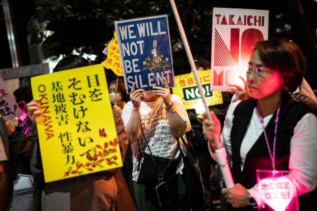 People protest against the killing of a woman in Okinawa allegedly committed by a US Marine Corps member, in front of the Prime Minister's Office in Tokyo on October 5, 2026. A woman's murder allegedly committed by a US Marine in Okinawa is a "heinous crime", Japan's premier said on October 5, as the new accusation of violence involving American forces sparked public outrage. (Photo by Yuichi YAMAZAKI / AFP)
