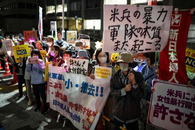 People protest against the killing of a woman in Okinawa allegedly committed by a US Marine Corps member, in front of the Prime Minister's Office in Tokyo on October 5, 2026. A woman's murder allegedly committed by a US Marine in Okinawa is a "heinous crime", Japan's premier said on October 5, as the new accusation of violence involving American forces sparked public outrage. (Photo by Yuichi YAMAZAKI / AFP)