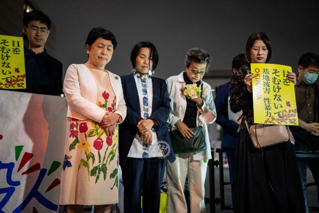 Protesters observe a moment of silence for a woman who was allegedly killed by a US Marine Corps member in Okinawa during a demonstration in front of the Prime Minister's Office in Tokyo on October 5, 2026. A woman's murder allegedly committed by a US Marine in Okinawa is a "heinous crime", Japan's premier said on October 5, as the new accusation of violence involving American forces sparked public outrage. (Photo by Yuichi YAMAZAKI / AFP)