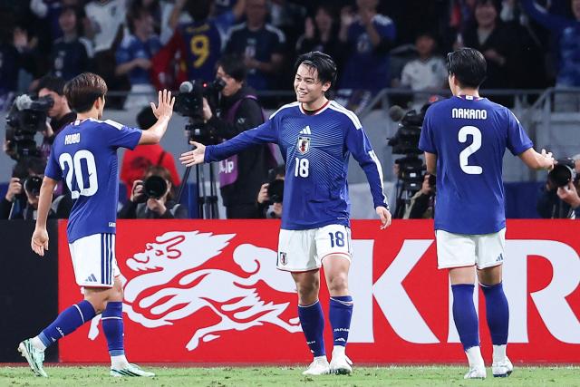 Japan's Ayase Ueda (C) celebrates after scoring a goal during the Kirin Cup football tournament final match between Japan and New Zealand at MUFG Stadium in Tokyo on October 5, 2026. (Photo by JIJI Press / AFP) / Japan OUT