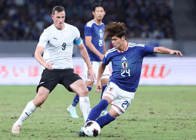 Japan's Kai Sano (R) tries get past New Zealand's Chris Wood during the Kirin Cup football tournament final between Japan and New Zealand at MUFG Stadium in Tokyo on October 5, 2026. (Photo by JIJI Press / AFP) / Japan OUT