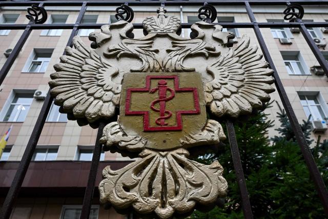 The logo of Russia's consumer and health watchdog Rospotrebnadzor sits on its grounds' fencing in Moscow on October 5, 2026. Russian officials on October 5, 2026 downplayed reports that a laboratory technician in Siberia had died of plague, insisting the situation was under control and that post-mortem tests had not found traces of the disease. (Photo by Igor IVANKO / AFP)