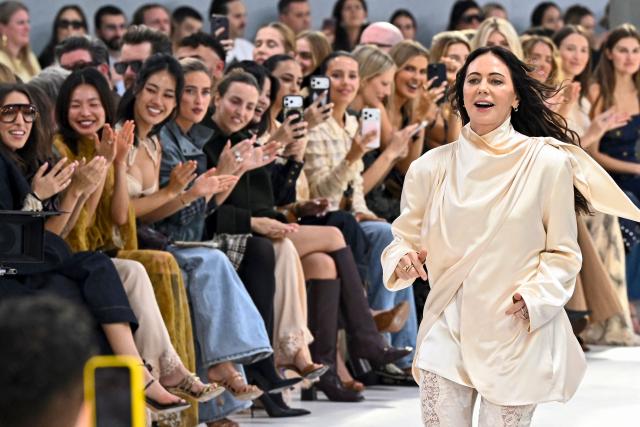 Australian designer Nicky Zimmermann for Zimmermann aknowledges the audience a the end of the Zimmermann Women's Spring/Summer 2027 collection fashion show as part of the Paris Fashion Week, in Paris on October 5, 2026. (Photo by JULIEN DE ROSA / AFP)