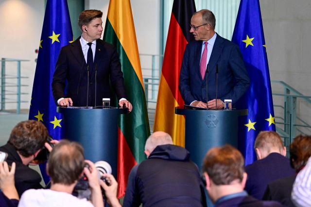 German Chancellor Friedrich Merz (R) and Lithuania's Prime Minister Mindaugas Sinkevicius deliver a joint press conference after talks at the Chancellery in Berlin on October 5, 2026. (Photo by John MACDOUGALL / AFP)