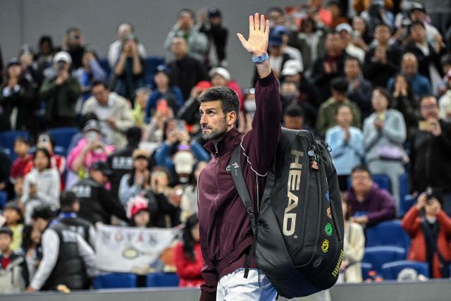 Serbia’s Novak Djokovic leaves the court after Russia’s Daniil Medvedev was disqualified for hitting a ball into the stands, injuring a spectator, during their men’s singles semi-final at the China Open tennis tournament in Beijing on October 5, 2026. (Photo by GREG BAKER / AFP)