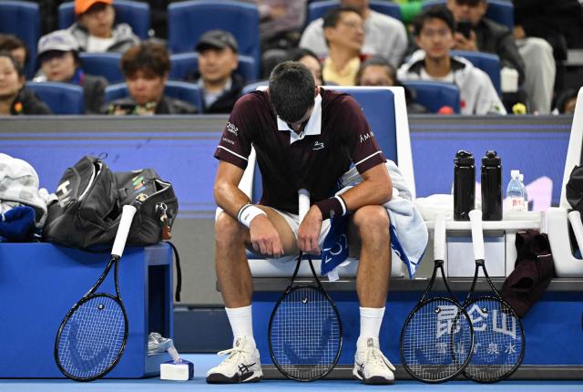 Serbia’s Novak Djokovic rests during his men’s singles semi-final match against Russia’s Daniil Medvedev at the China Open tennis tournament in Beijing on October 5, 2026. (Photo by GREG BAKER / AFP)