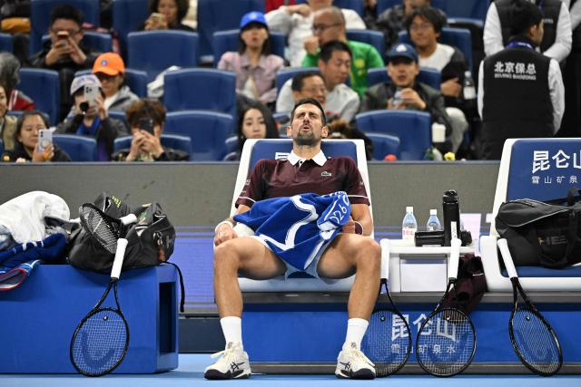 Serbia’s Novak Djokovic rests during his men’s singles semi-final match against Russia’s Daniil Medvedev at the China Open tennis tournament in Beijing on October 5, 2026. (Photo by GREG BAKER / AFP)