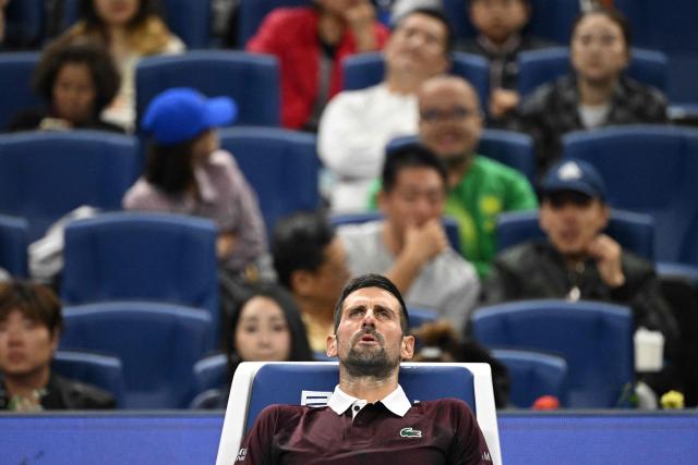 Serbia’s Novak Djokovic rests during his men’s singles semi-final match against Russia’s Daniil Medvedev at the China Open tennis tournament in Beijing on October 5, 2026. (Photo by GREG BAKER / AFP)