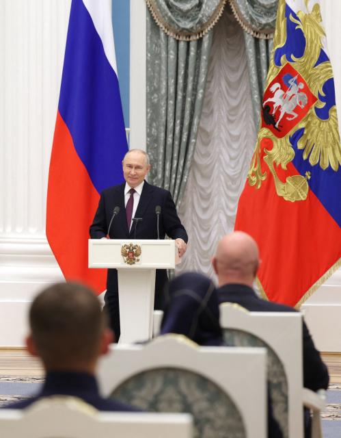 In this pool photograph distributed by the Russian state agency Sputnik, Russia's President Vladimir Putin hosts a ceremony to present state awards to mentors and teachers of participants in Russia's military action in Ukraine, at the Kremlin in Moscow on October 5, 2026. (Photo by Gavriil Grigorov / POOL / AFP)