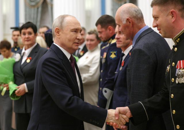 In this pool photograph distributed by the Russian state agency Sputnik, Russia's President Vladimir Putin hosts a ceremony to present state awards to mentors and teachers of participants in Russia's military action in Ukraine, at the Kremlin in Moscow on October 5, 2026. (Photo by Gavriil Grigorov / POOL / AFP)