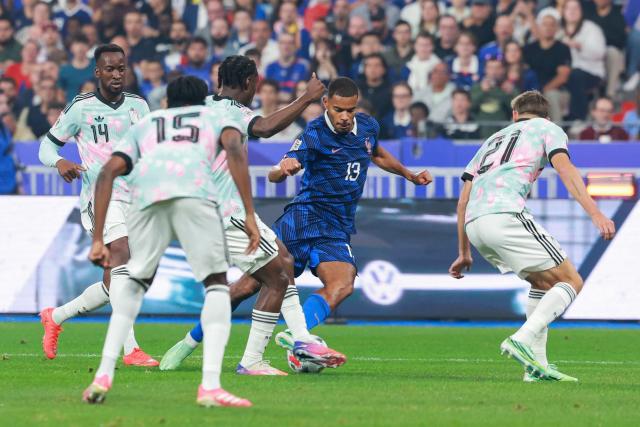 France's midfielder #13 Andy Diouf (C) runs with the ball near Belgium's forward #14 Dodi Lukebakio, Belgium's defender #15 Nathan Ngoy and Belgium's defender #21 Timothy Castagne during the UEFA Nations League Group A1 football match between France and Belgium at the Stade de France in Saint-Denis, north of Paris, on October 5, 2026. (Photo by Kenzo TRIBOUILLARD / AFP)