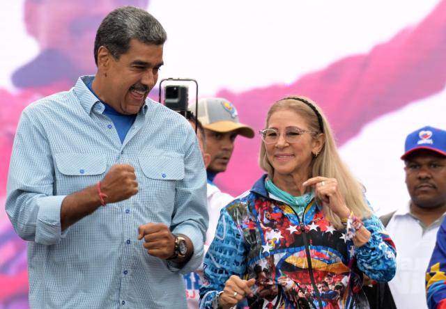 (FILES) Venezuelan President and presidential candidate Nicolas Maduro (L) dances next to his wife, Cilia Flores, at his campaign closing rally in Caracas on July 25, 2024, ahead of Sunday's presidential election. Ousted former Venezuelan president Nicolas Maduro's jailed wife Cilia Flores has a "very delicate" heart condition requiring surgery, Maduro's son told AFP on October 5, 2026, after Flores requested to be released on house arrest. (Photo by Yuri CORTEZ / AFP)