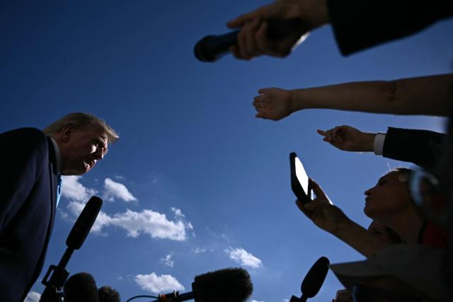 US President Donald Trump talks to the media before boarding Marine One as he departs from the South Lawn of the White House in Washington, DC, on October 5, 2026. Trump is travelling to Nebraska to speak at a campaign rally. (Photo by Brendan SMIALOWSKI / AFP)