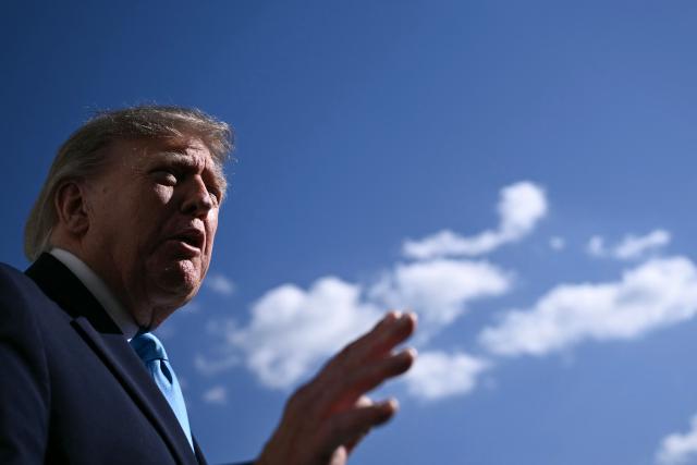 US President Donald Trump talks to the media before boarding Marine One as he departs from the South Lawn of the White House in Washington, DC, on October 5, 2026. Trump is travelling to Nebraska to speak at a campaign rally. (Photo by Brendan SMIALOWSKI / AFP)