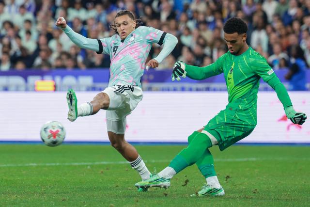 France's goalkeeper #01 Guillaume Restes (R) shoots the ball past Belgium's midfielder #19 Diego Moreira during the UEFA Nations League Group A1 football match between France and Belgium at the Stade de France in Saint-Denis, north of Paris, on October 5, 2026. (Photo by Kenzo TRIBOUILLARD / AFP)