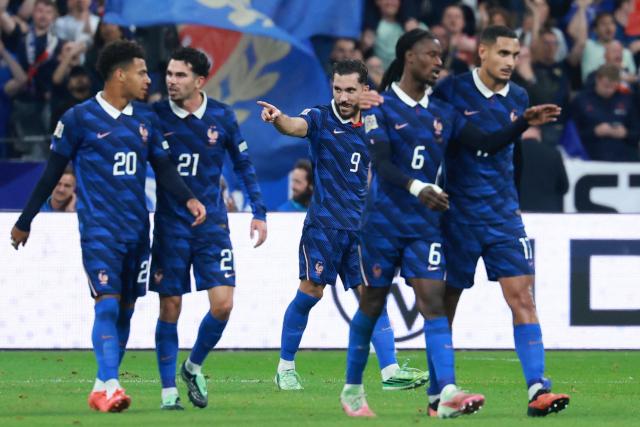 France's midfielder #09 Rayan Cherki celebrates with teammates scoring his team's second goal during the UEFA Nations League Group A1 football match between France and Belgium at the Stade de France in Saint-Denis, north of Paris, on October 5, 2026. (Photo by Kenzo TRIBOUILLARD / AFP)