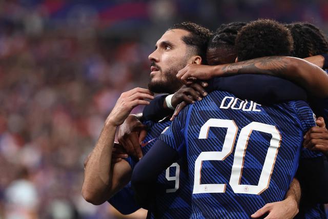 France's midfielder #09 Rayan Cherki (L) celebrates with teammates after scoring his team's second goal during the UEFA Nations League Group A1 football match between France and Belgium at the Stade de France in Saint-Denis, north of Paris, on October 5, 2026. (Photo by FRANCK FIFE / AFP)