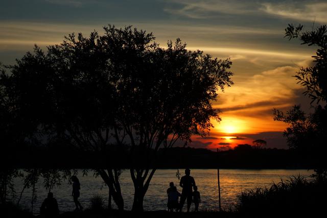 People watch the sunset on the Amazon River in Leticia, Amazonas Department, Colombia, on October 5, 2026. (Photo by Pablo VERA / AFP)