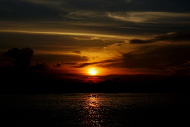 A boat sails along the Amazon River at sunset in Leticia, Amazonas Department, Colombia, on October 5, 2026. (Photo by Pablo VERA / AFP)