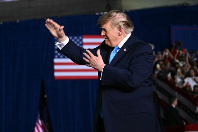 US President Donald Trump gestures as he walks on stage to speak during a campaign rally at Pinnacle Bank Expo Center in Grand Island, Nebraska, on October 5, 2026. (Photo by Kent NISHIMURA / AFP)