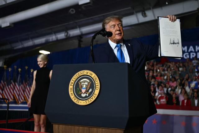 US President Donald Trump shows the crowd an executive order he just signed during a campaign rally at Pinnacle Bank Expo Center in Grand Island, Nebraska, on October 5, 2026. (Photo by Kent NISHIMURA / AFP)