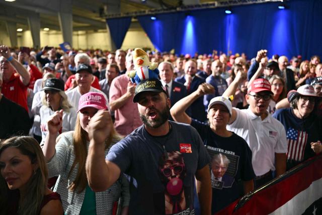 Supporters cheer US President Donald Trump as he speaks during a campaign rally at Pinnacle Bank Expo Center in Grand Island, Nebraska, on October 5, 2026. (Photo by Kent NISHIMURA / AFP)