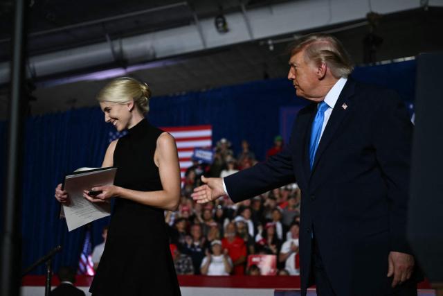 US President Donald Trump thanks executive assistant Natalie Harp during a campaign rally at Pinnacle Bank Expo Center in Grand Island, Nebraska, on October 5, 2026. (Photo by Kent NISHIMURA / AFP)