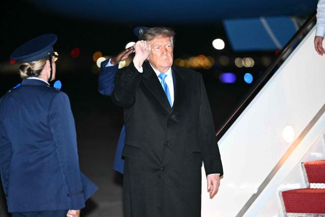 US President Donald Trump makes a fist after he disembarked from Air Force One at Joint Base Andrews, Maryland, on October 5, 2026. Trump is returning from Nebraska where he spoke at a campaign rally. (Photo by Kent NISHIMURA / AFP)