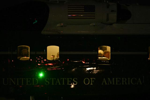 US President Donald Trump is seen aboard Marine One with executive assistant Natalie Harp at Joint Base Andrews, Maryland, on October 5, 2026. Trump is returning from Nebraska where he spoke at a campaign rally. (Photo by Kent NISHIMURA / AFP)