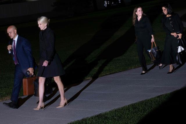 Director of White House Oval Office Operations Walt Nauta and Executive assistant to the President Natalie Harp follow US President Donald Trump from Marine One to the White House in Washington, DC on October 5, 2026. Trump is returning from to Nebraska where he spoke at a campaign rally. (Photo by Brendan Smialowski / AFP)
