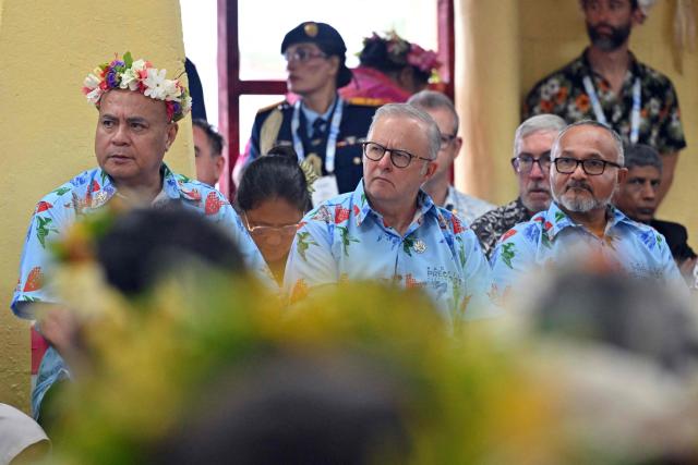 Tuvalu's Prime Minister Feleti Teo (L), Australia's Prime Minister Anthony Albanese (C) and Solomon Islands' Prime Minister Matthew Wale attend a traditional welcome ceremony during the Pacific Pre-COP31 meeting in Tuvalu on October 6, 2026. (Photo by MICK TSIKAS / POOL / AFP)