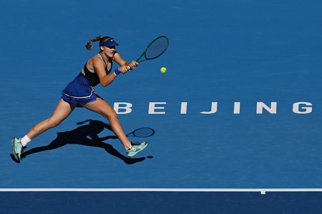Russia’s Mirra Andreeva hits a return to Ukraine’s Daria Snigur during their women’s singles match at the China Open tennis tournament in Beijing on October 6, 2026. (Photo by GREG BAKER / AFP)