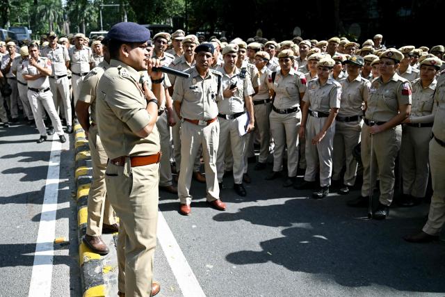 Police personnel assemble in front of the Election Commission of India office in New Delhi on October 6, 2026, during a demonstration against the country's Chief Election Commissioner Gyanesh Kumar calling for his resignation over alleged irregularities in the Special Intensive Revision (SIR) of electoral rolls. India's Supreme Court ordered the government and the national election body on October 5, to explain decisions linked to a large-scale revision of voter rolls that prompted accusations of wrongdoing. Opposition parties and activists have organised protests and called for the resignation of Kumar, alleging that the revision had improperly removed millions of names from voter lists. (Photo by Arun SANKAR / AFP)