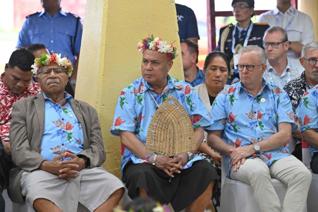 Fiji's Prime Minister Sitiveni Rabuka (L), Tuvalu's Prime Minister Feleti Teo (C) and Australia's Prime Minister Anthony Albanese during a traditional welcome ceremony during the Pacific Pre-COP31 meeting in Tuvalu on October 6, 2026. (Photo by MICK TSIKAS / POOL / AFP)