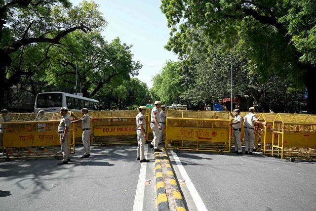 Police personnel barricade a street near the Election Commission of India office in New Delhi on October 6, 2026, during a demonstration against the country's Chief Election Commissioner Gyanesh Kumar calling for his resignation over alleged irregularities in the Special Intensive Revision (SIR) of electoral rolls. India's Supreme Court ordered the government and the national election body on October 5, to explain decisions linked to a large-scale revision of voter rolls that prompted accusations of wrongdoing. Opposition parties and activists have organised protests and called for the resignation of Kumar, alleging that the revision had improperly removed millions of names from voter lists. (Photo by Arun SANKAR / AFP)