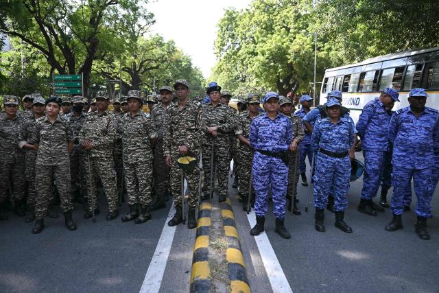 Central Reserve Police Force (CRPF) and Rapid Action Force (RAF) personnel assemble near the Election Commission of India office in New Delhi on October 6, 2026, during a demonstration against the country's Chief Election Commissioner Gyanesh Kumar calling for his resignation over alleged irregularities in the Special Intensive Revision (SIR) of electoral rolls. India's Supreme Court ordered the government and the national election body on October 5, to explain decisions linked to a large-scale revision of voter rolls that prompted accusations of wrongdoing. Opposition parties and activists have organised protests and called for the resignation of Kumar, alleging that the revision had improperly removed millions of names from voter lists. (Photo by Arun SANKAR / AFP)