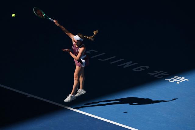 Ekaterina Alexandrova serves to Czech Republic’s Linda Noskova during their women’s singles match at the China Open tennis tournament in Beijing on October 6, 2026. (Photo by ADEK BERRY / AFP)