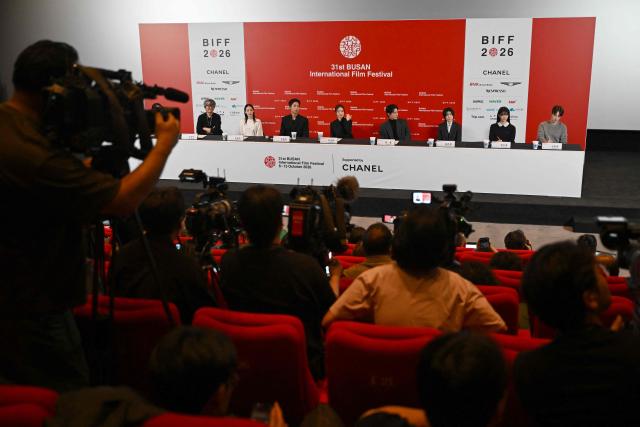 (L-R) South Korean Director Kim Jong-kwan and actors Kim Min-ha, Joo Jong-hyuk, Han Sun-hwa, Chang Ryul, Shim Eun-kyung, Jeon So-young, and Kim Dong-hwi attend a press conference for the opening film "The Table: Day and Night" of the 31st Busan International Film Festival (BIFF) at the Busan Cinema Center in Busan on October 6, 2026. (Photo by Jung Yeon-je / AFP)